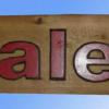 Hand carved and painted wood sign.